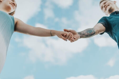 amanti-amore-mani-cielo-nuvole-tatuaggio-intimità